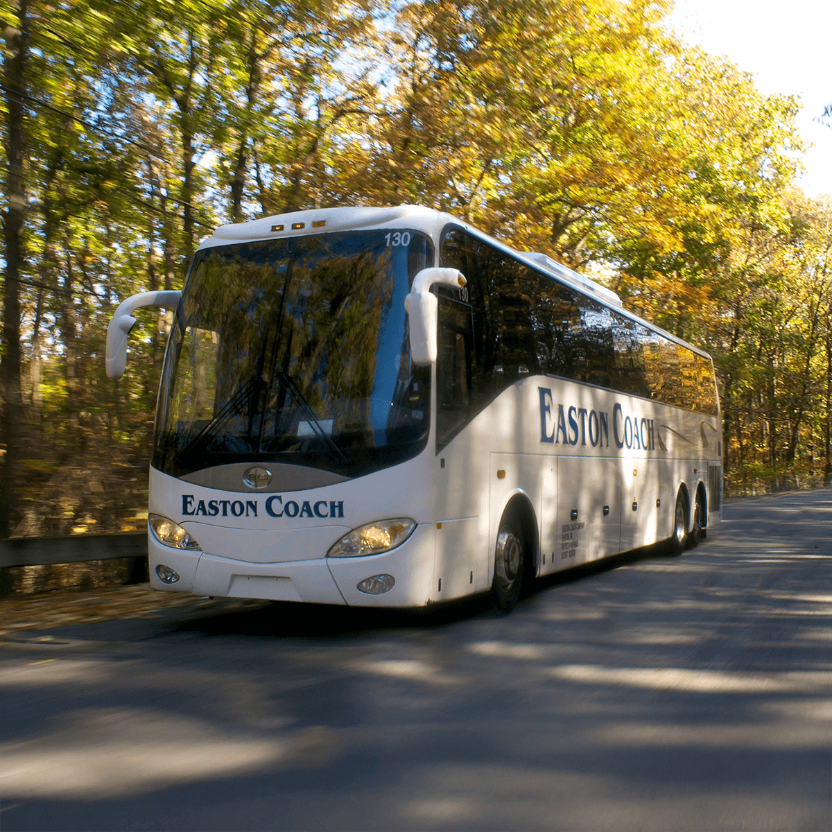 a coach bus driving on a road